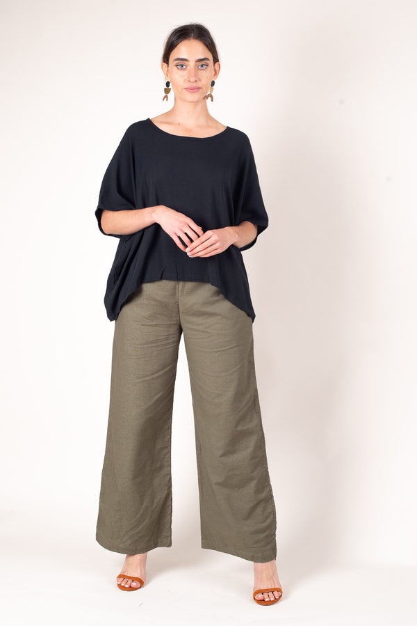 A front view of the green reclaimed linen sothea trouser, these sustainably made pants can be dressed up with heels or worn casually with sneakers or flats. 